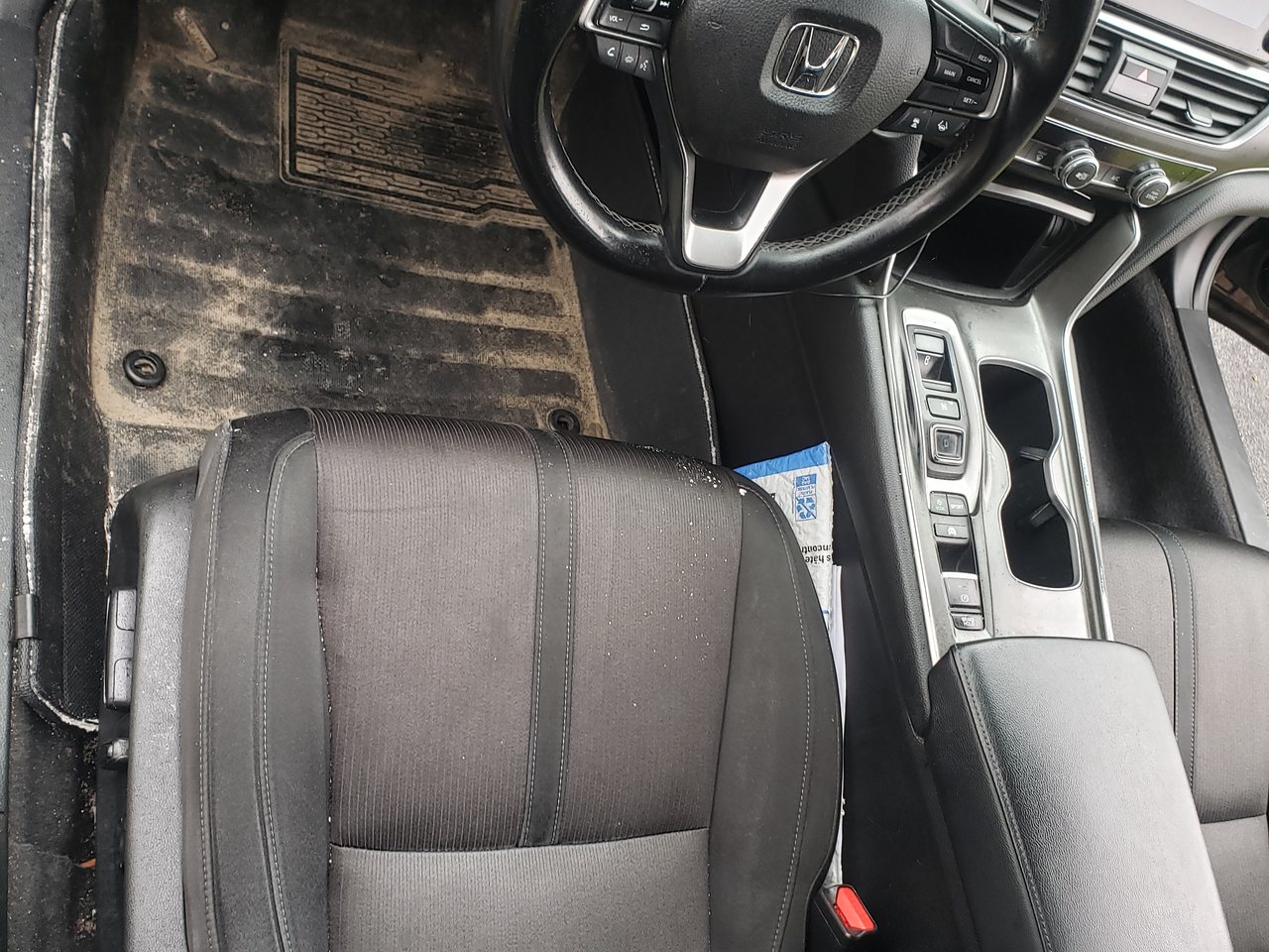 Salt-caked driver footwell and mat before detailing